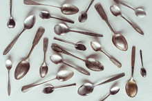 Vintage metal spoons on white background