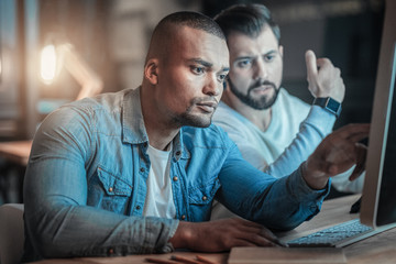 software development. concentrated focused two colleges programming together while posing on blurred