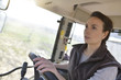 © goodluz - Farmer woman driving tractor