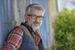 © goodluz - Portrait of farmer leaning on cowshed door