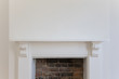 Victoriran wooden fireplace surround with white walls
