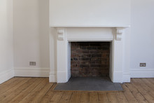 Victoriran Wooden Fireplace Surround With White Walls