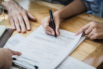 success business contract deasl with sale represent and clients meeting with paper document contract and pen close up on wooden table and background