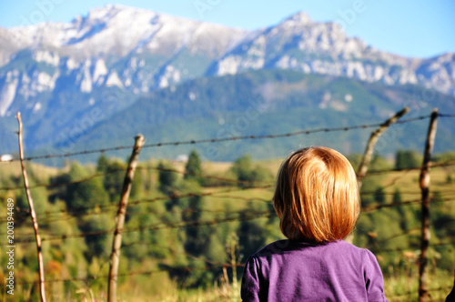 Back Side Portrait Of A Kid In Focus Blonde Girl With Short Hair