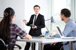 © chagin - Businessman explains to businessmen a new project