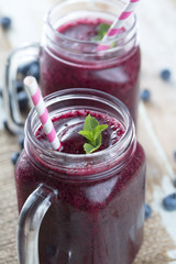 Poster - Berry smoothie in glass with blueberries, mint and cocktail tube