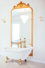 Vintage White Color Bathroom Near Mirror With A Golden Frame. Art Deco. Luxury Interior