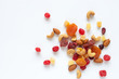 © p-fotography - healthy snack: mixed nuts and dried fruits on white background from above, almond, pineapple, cranberry, papaya, apple, strawberry, cherry, apricot, casshew.