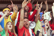 © Marino Bocelli - group of fans dressed in red color watching a sports event