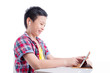 © gamelover - Young asian boy wearing headset and using tablet computer over white background