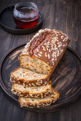 Banana cake with seeds and a cup of hot tea