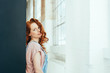 © contrastwerkstatt - Thoughtful attractive young woman with red hair