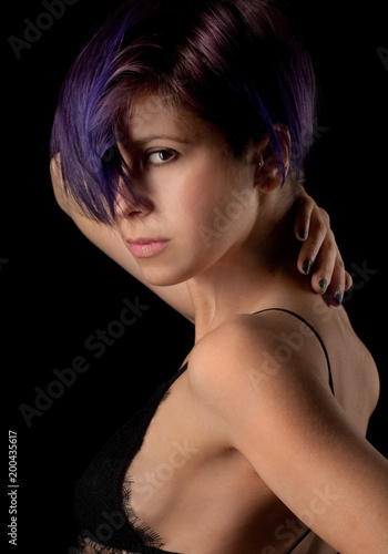 Portrait Of Woman With Short Purple Hair Against Black Background