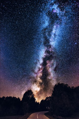 Wall Mural - Milky Way galaxy over the forest and road. Milky Way galaxy over the mountain forest and road, Rajac, Serbia. The night sky is astronomically accurate.
