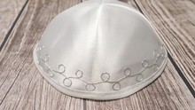 Jewish Traditional White Kippah On A Table With The Camera Turning Around