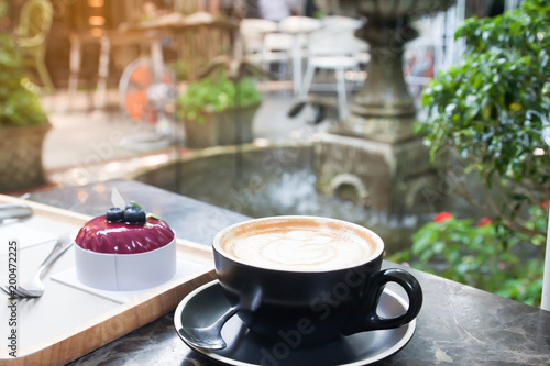 Coffee And Cake On Table In Cafe With Beautiful Garden Backyard