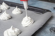 Whipped cream on baking paper. Meringue of the proteins and sugars. Step-by-step recipe for meringue cookies. Process of meringue preparation