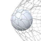 Fototapeta Sport - White clear leather soccer ball inside the net, in a net.