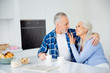 © deagreez - Portrait of lovely sweet stylish attractive couple sitting at table with cups of coffee bakery, embracing looking at each other, spending morning together indoor