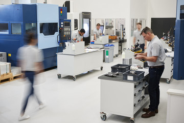 Wall Mural - busy engineering workshop with workers using cnc machinery