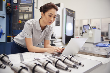 Wall Mural - female engineer using cad programming software on laptop
