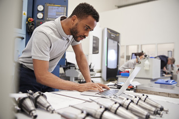 Wall Mural - male engineer using cad programming software on laptop