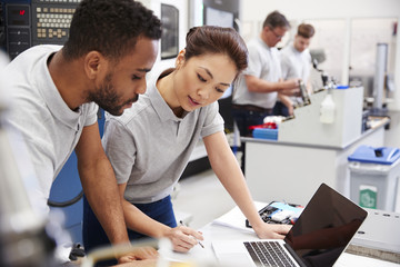 Wall Mural - two engineers using cad programming software on laptop