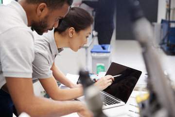 Wall Mural - two engineers using cad programming software on laptop
