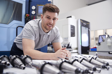 Wall Mural - portrait of male engineer with cad drawings in factory