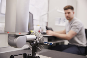 Wall Mural - male engineer uses cmm coordinate measuring machine in factory