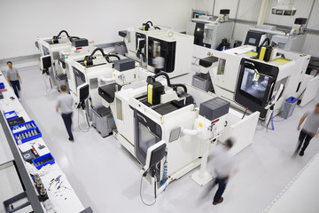 Wall Mural - Overhead View Of Engineering Workshop With Workers Using CNC Machinery