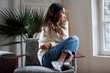 Sad thoughtful teen girl sits on chair feels depressed, offended or lonely, upset young woman suffers from abuse, harassment or heartbreak, grieving lady or violence victim has psychological problem