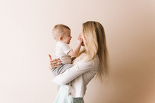 Mother Playing With Baby Boy, Happy Family Having Fun Indoor, Cheerful Sweet Kid Portrait, Mom And Child, Healthy Toddler, Lifting Throwing Carrying Holding Up Game