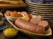 © Kate Baldwin - bratwurst and cheese on abundant table