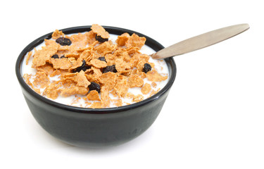 milk, bran and raisin cereal in a bowl on white