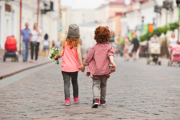 Wall Mural - boy and girl walking on the street