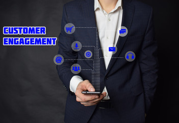 A businessman shows an inscription:CUSTOMER ENGAGEMENT