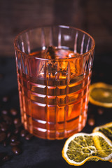 An ice cube floats in alcohol in a glass.