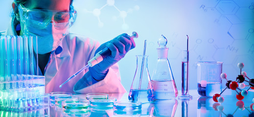 Wall Mural - chemistry laboratory - woman with pipettes and test tubes