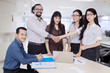 © Creativa Images - Business people shaking hands in the boardroom