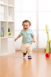 © Oksana Kuzmina - First steps of baby toddler learning to walk in living room. Footwear for little children.