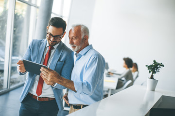 Businessmen with digital tablet in office