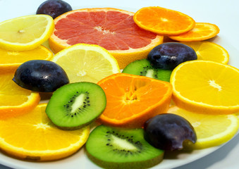 Colorful of cut fruits close up. Vegetarian food on the plate. 
