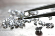 Leinwandbild Motiv brilliant cut diamond held by tweezers