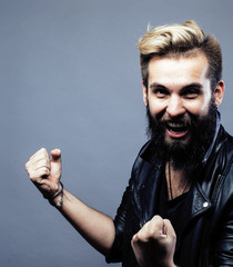 portrait of young bearded hipster guy on gray dark background cl