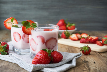 Wall Mural - Strawberry yogurt in a glass on a wooden table       