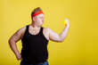 © alfa27 - Fat man shows his muscle while holding dumbbell in hand