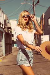 happy young woman walking in the street.