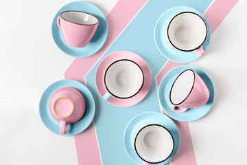 Wall Mural - Elegant porcelain blue and pink cups on abstract background