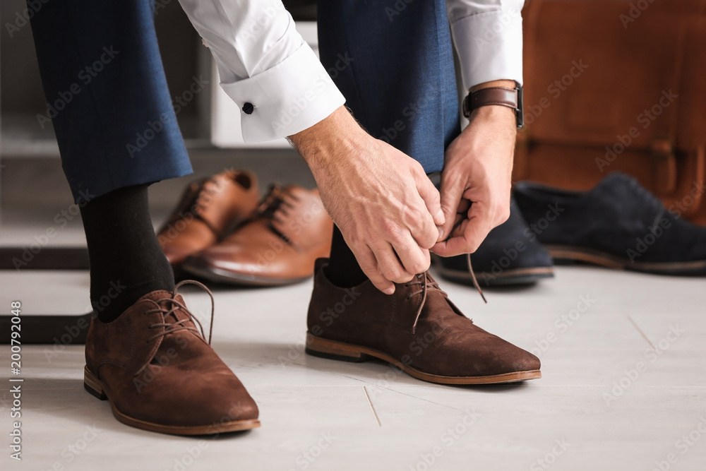 Man trying on new shoes indoors, closeup